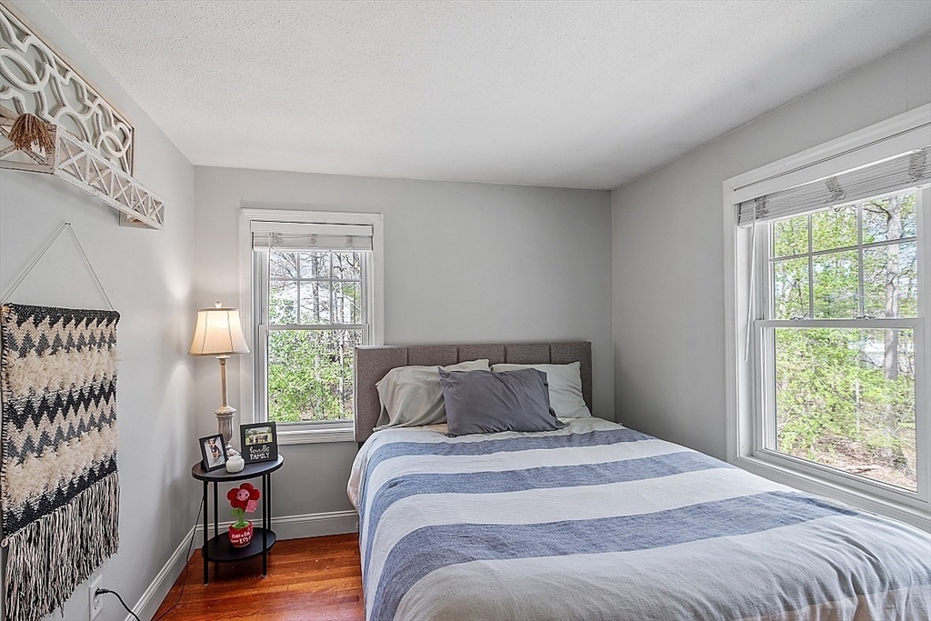 26 Pondover Road, Unit 26 Billerica, MA 01821 - Photo 9 of 23 a bedroom with a bed and wooden floor