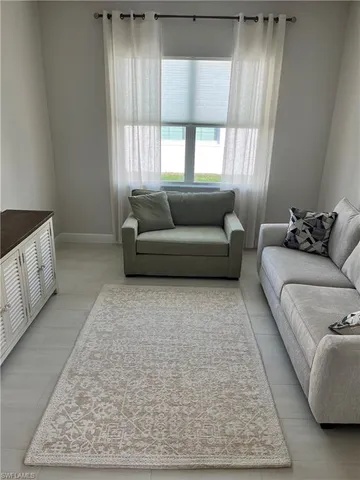 a living room with furniture and a rug