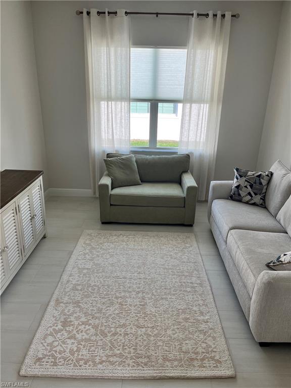 9195 Cayman Drive Naples, FL 34114 - Photo 15 of 29 a living room with furniture and a rug