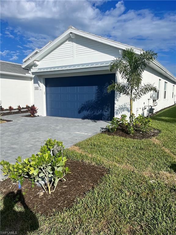 9195 Cayman Drive Naples, FL 34114 - Photo 2 of 29 a front view of a house with a yard