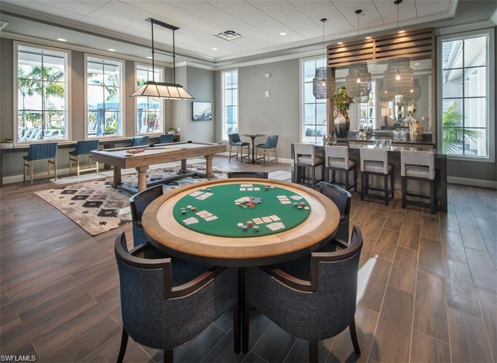9195 Cayman Drive Naples, FL 34114 - Photo 23 of 29 a view of a dining room with furniture window and wooden floor