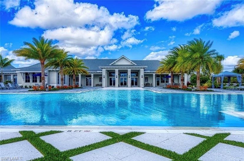 9195 Cayman Drive Naples, FL 34114 - Photo 26 of 29 a front view of a house with a garden