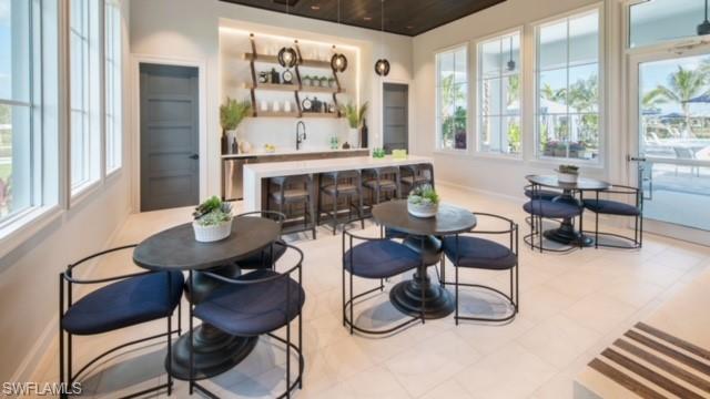 9195 Cayman Drive Naples, FL 34114 - Photo 28 of 29 a living room with furniture and a large window