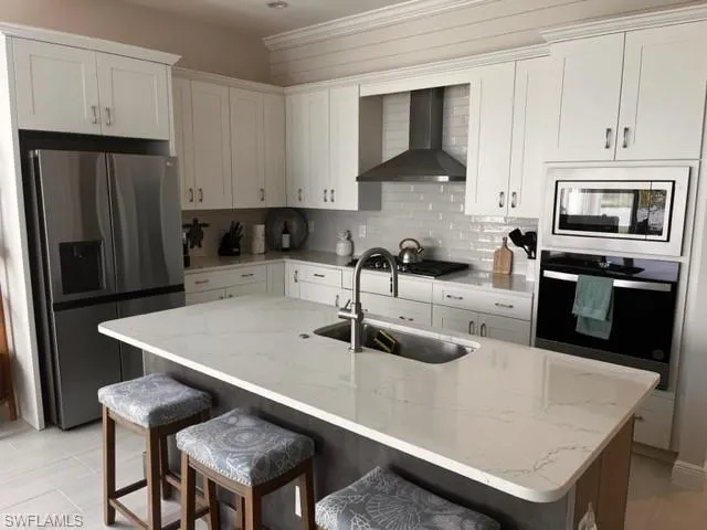 a kitchen with a sink a microwave and cabinets