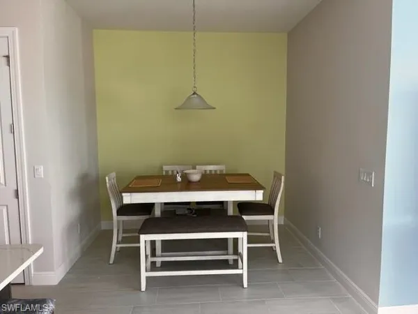 a view of a room with a table and chairs