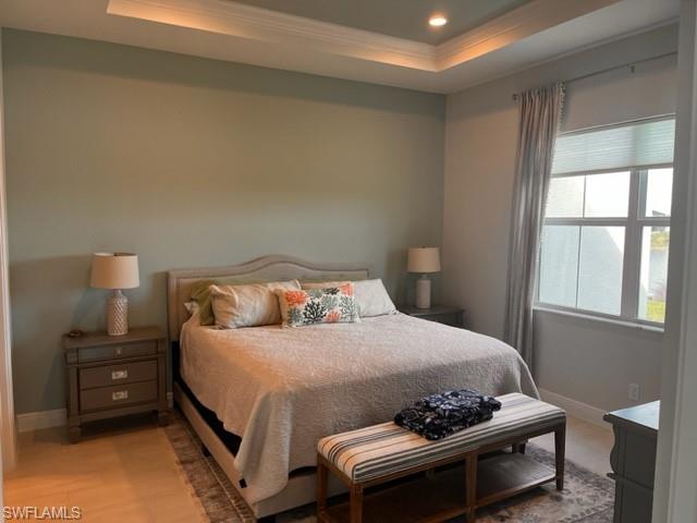 9195 Cayman Drive Naples, FL 34114 - Photo 7 of 29 a bedroom with a bed and wooden floor