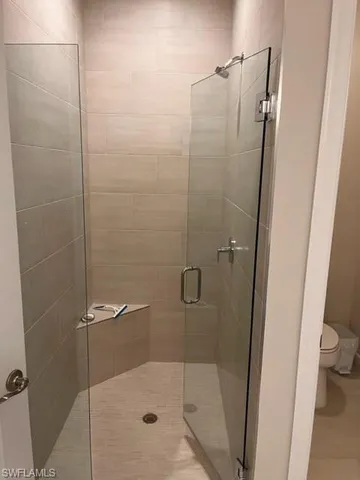 a bathroom with a shower and a toilet