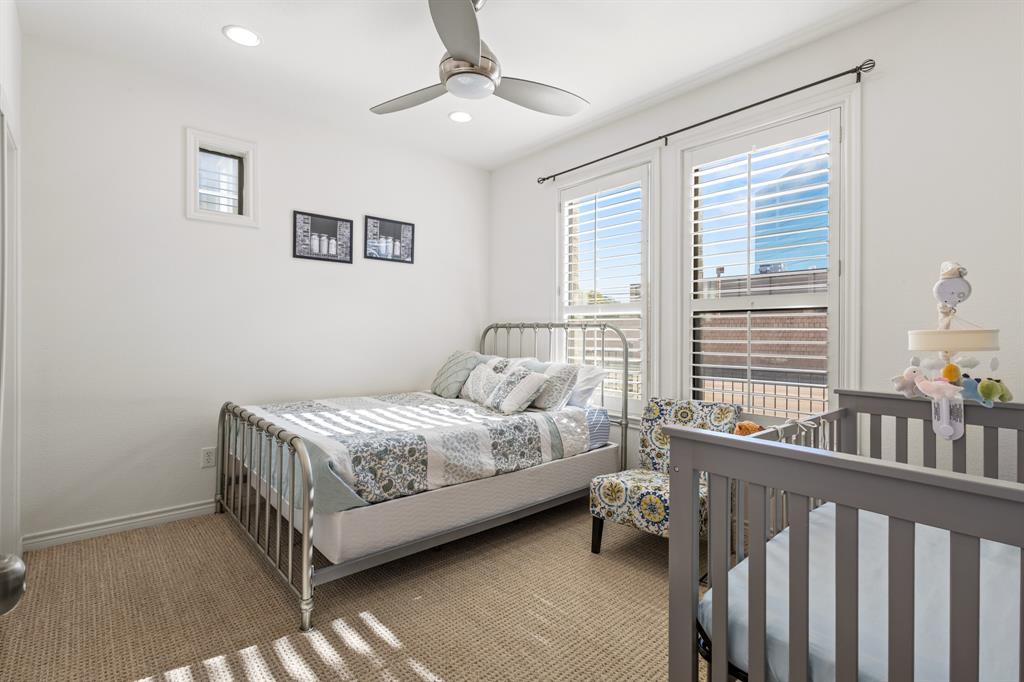 13900 Noel Road, Unit 23 Dallas, TX 75240 - Photo 24 of 28 a bedroom with a bed next to a window