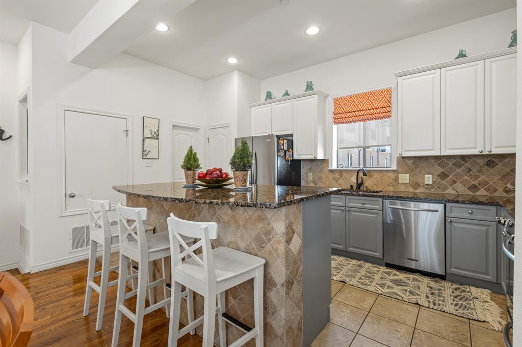 13900 Noel Road, Unit 23 Dallas, TX 75240 - Photo 6 of 28 a kitchen with stainless steel appliances granite countertop a sink and a refrigerator