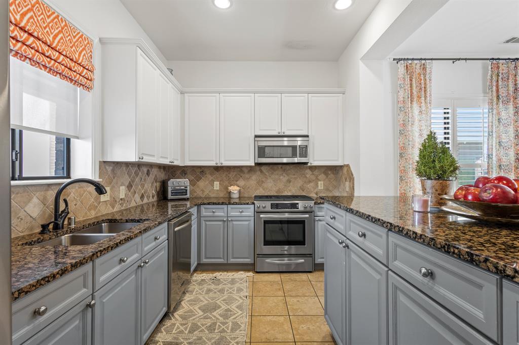 13900 Noel Road, Unit 23 Dallas, TX 75240 - Photo 7 of 28 a kitchen with granite countertop a sink stove and cabinets