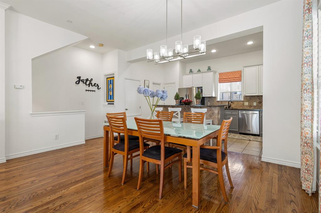 13900 Noel Road, Unit 23 Dallas, TX 75240 - Photo 10 of 28 a view of a dining room with furniture wooden floor and chandelier