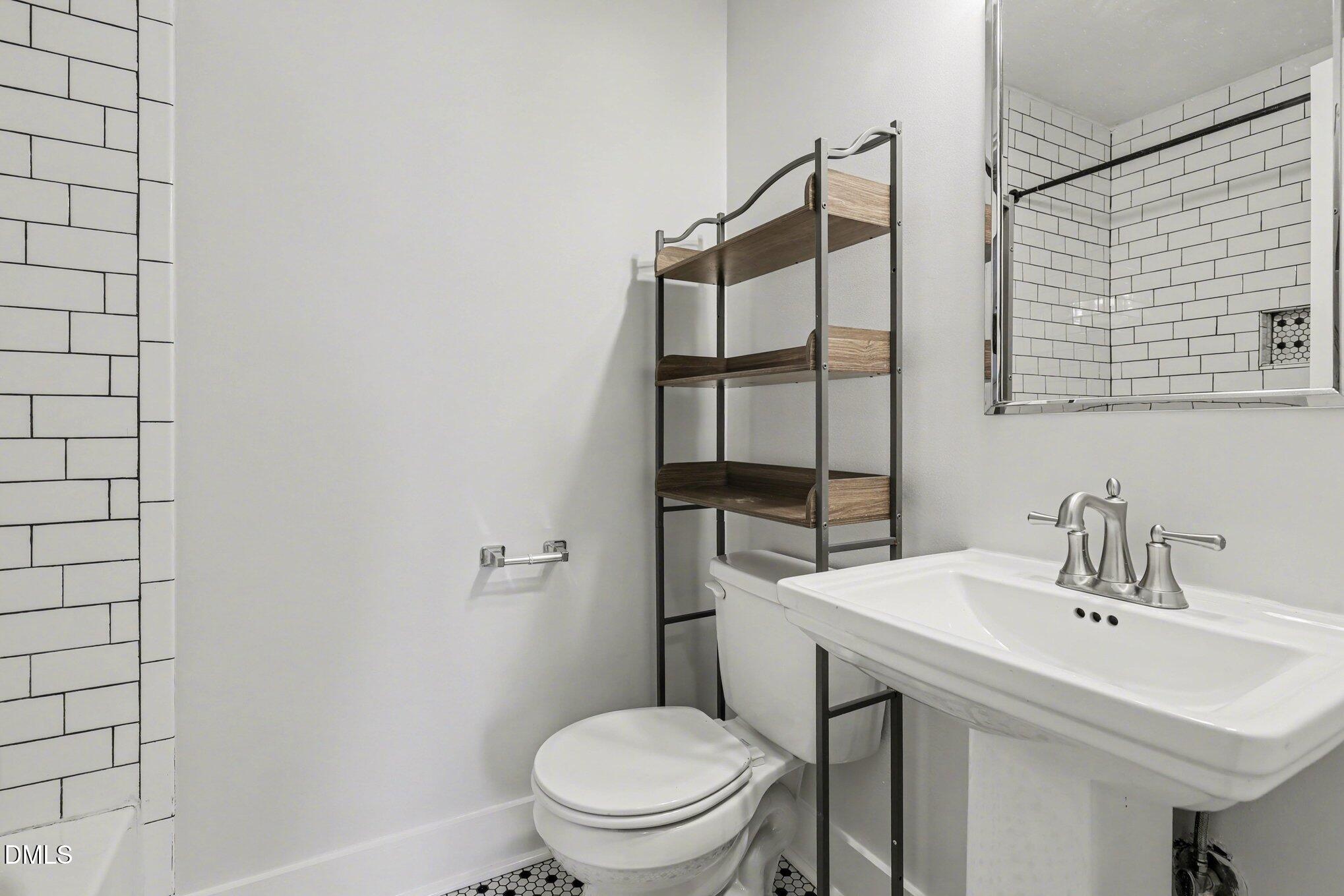 727 South State Street Raleigh, NC 27601 - Photo 15 of 30 a bathroom with a sink a toilet and shower