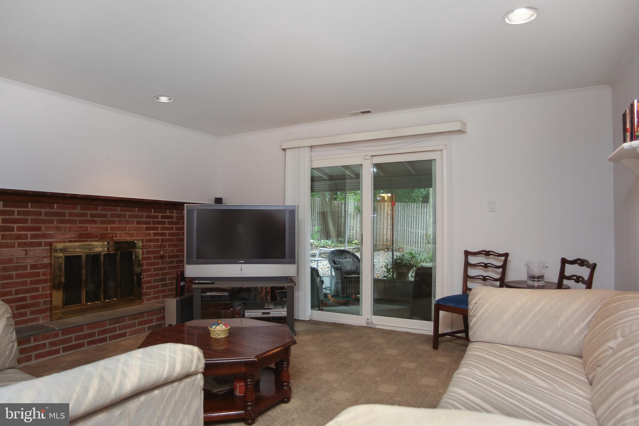 242 Springfield Avenue Philadelphia, PA 19118 - Photo 13 of 24 Lower level den with brick fireplace