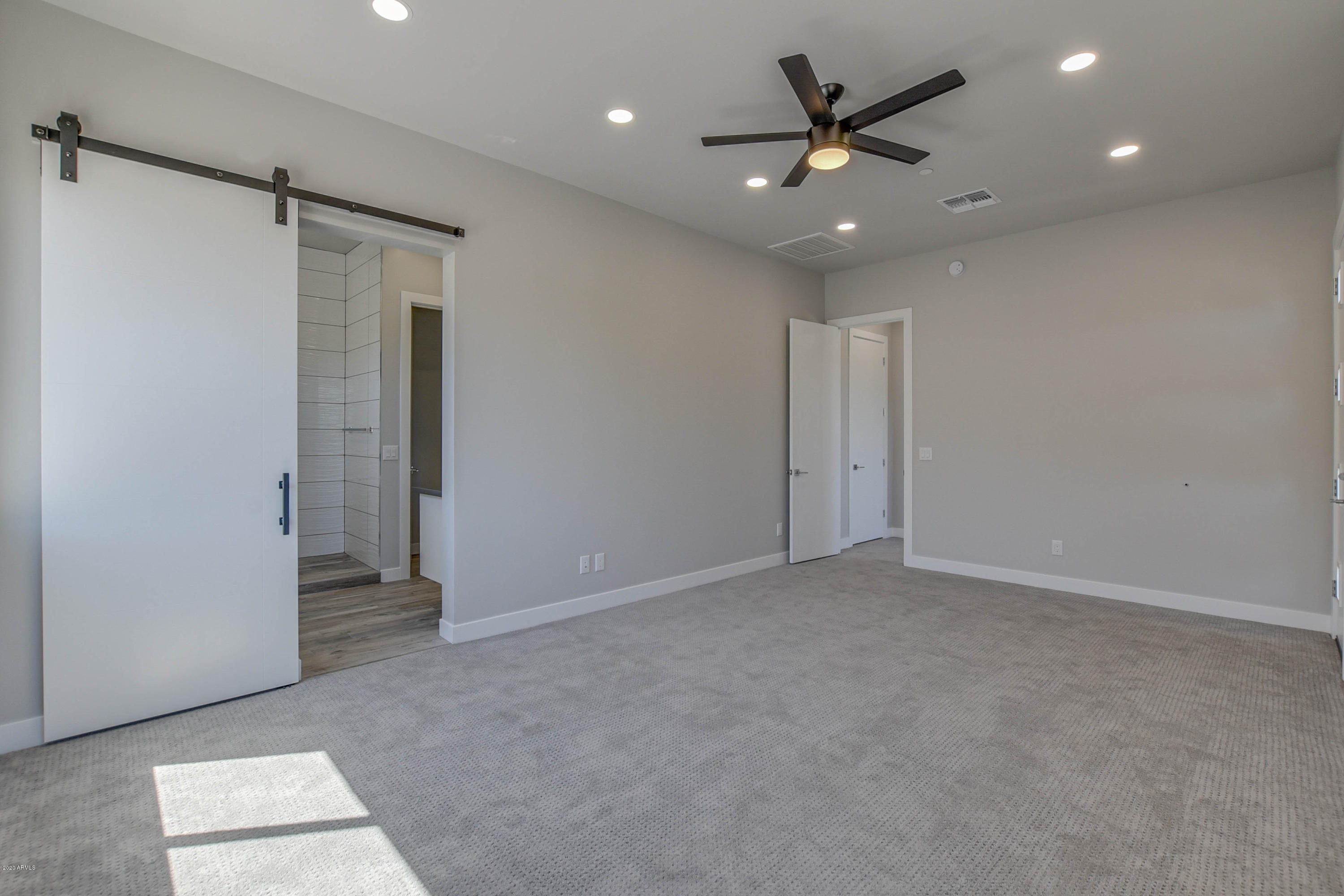 2645 East Osborn Road, Unit 6 Phoenix, AZ 85016 - Photo 11 of 43 wooden floor in an empty room with a ceiling fan