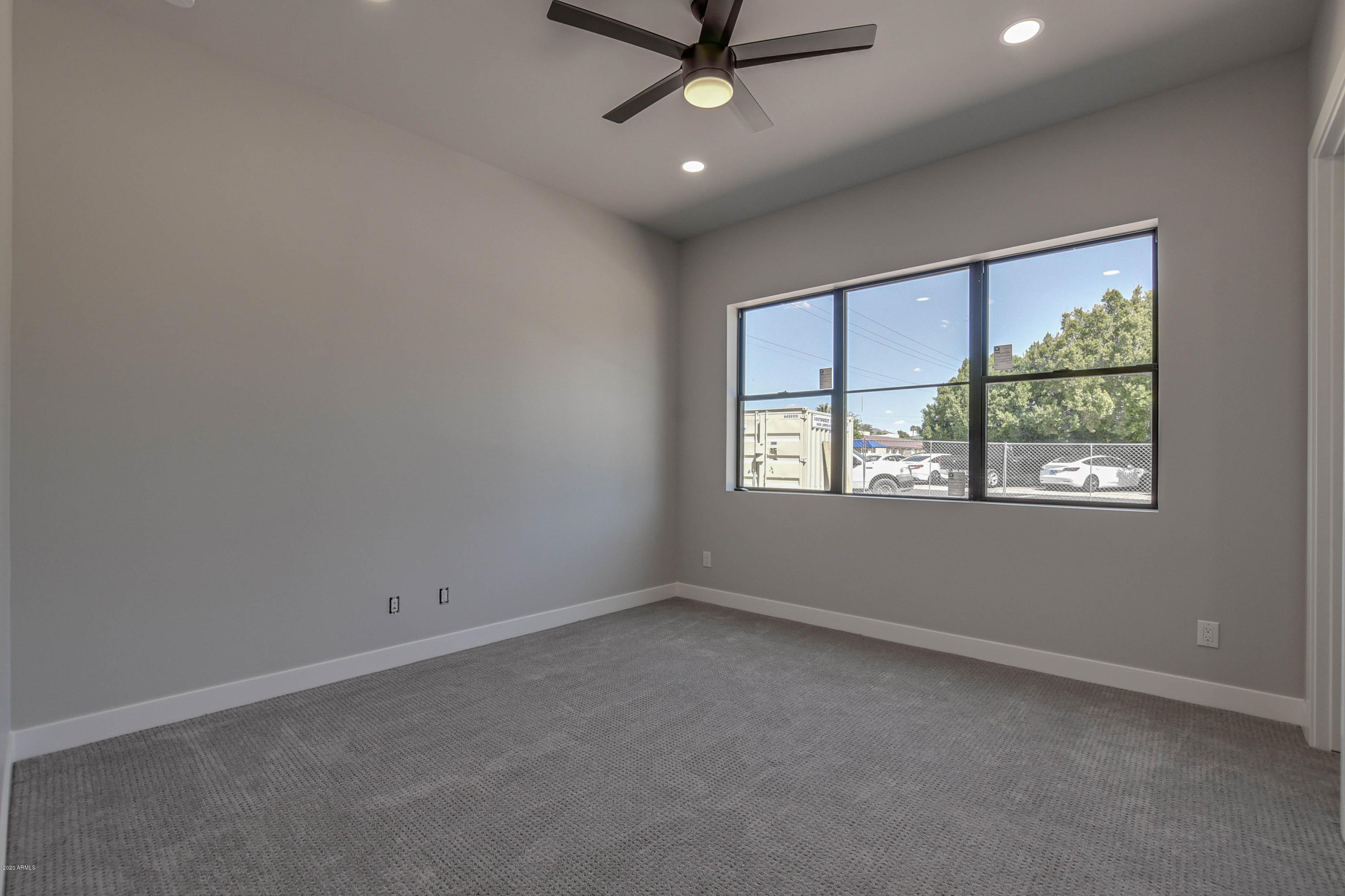 2645 East Osborn Road, Unit 6 Phoenix, AZ 85016 - Photo 12 of 43 an empty room with a window and a fan