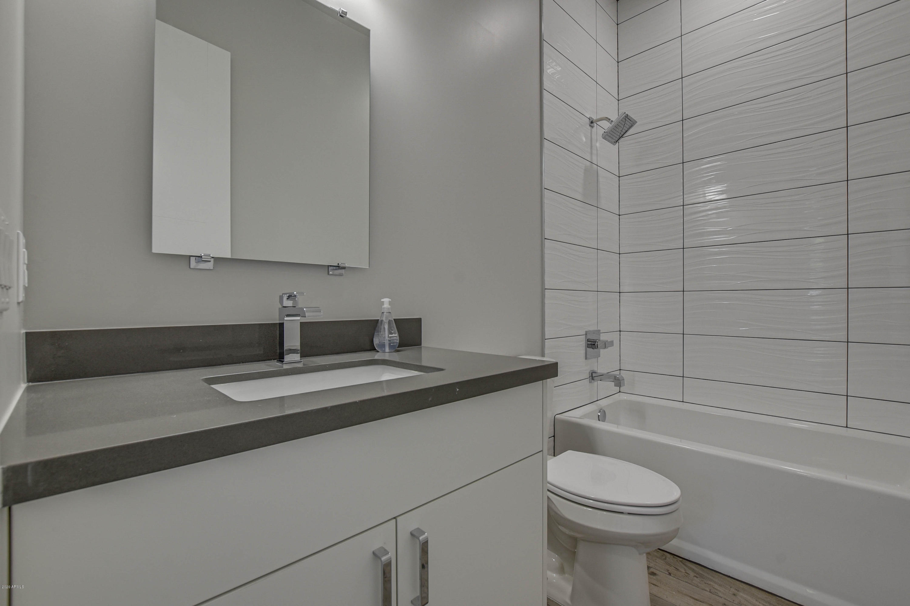 2645 East Osborn Road, Unit 6 Phoenix, AZ 85016 - Photo 13 of 43 a bathroom with a granite countertop sink a toilet and bathtub