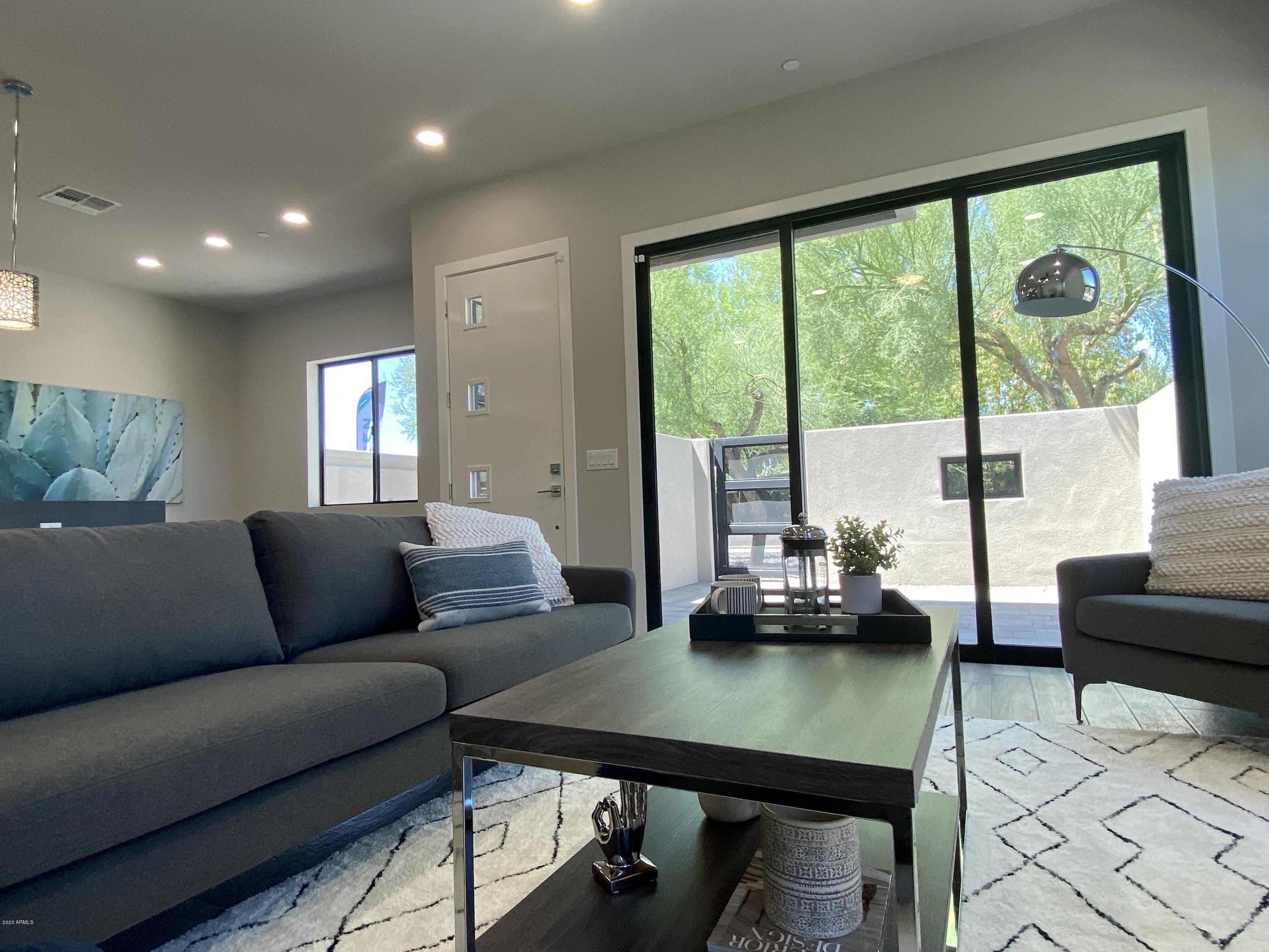 2645 East Osborn Road, Unit 6 Phoenix, AZ 85016 - Photo 2 of 43 a living room with furniture and a large window