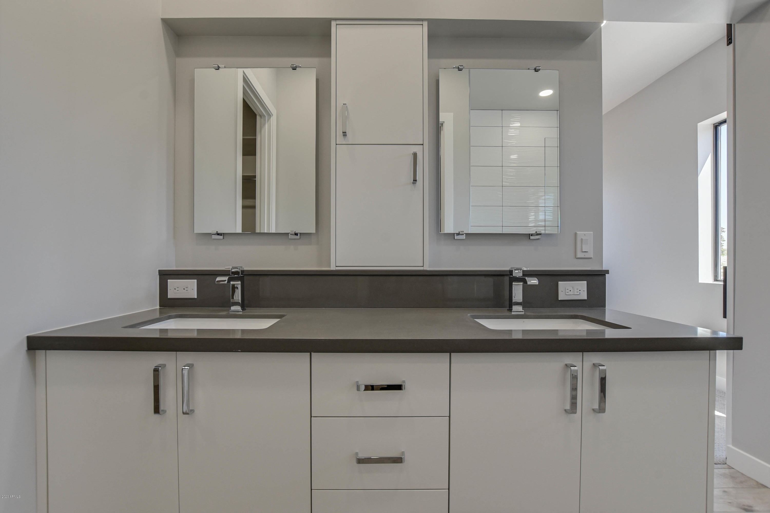 2645 East Osborn Road, Unit 6 Phoenix, AZ 85016 - Photo 24 of 43 a bathroom with cabinets and mirror