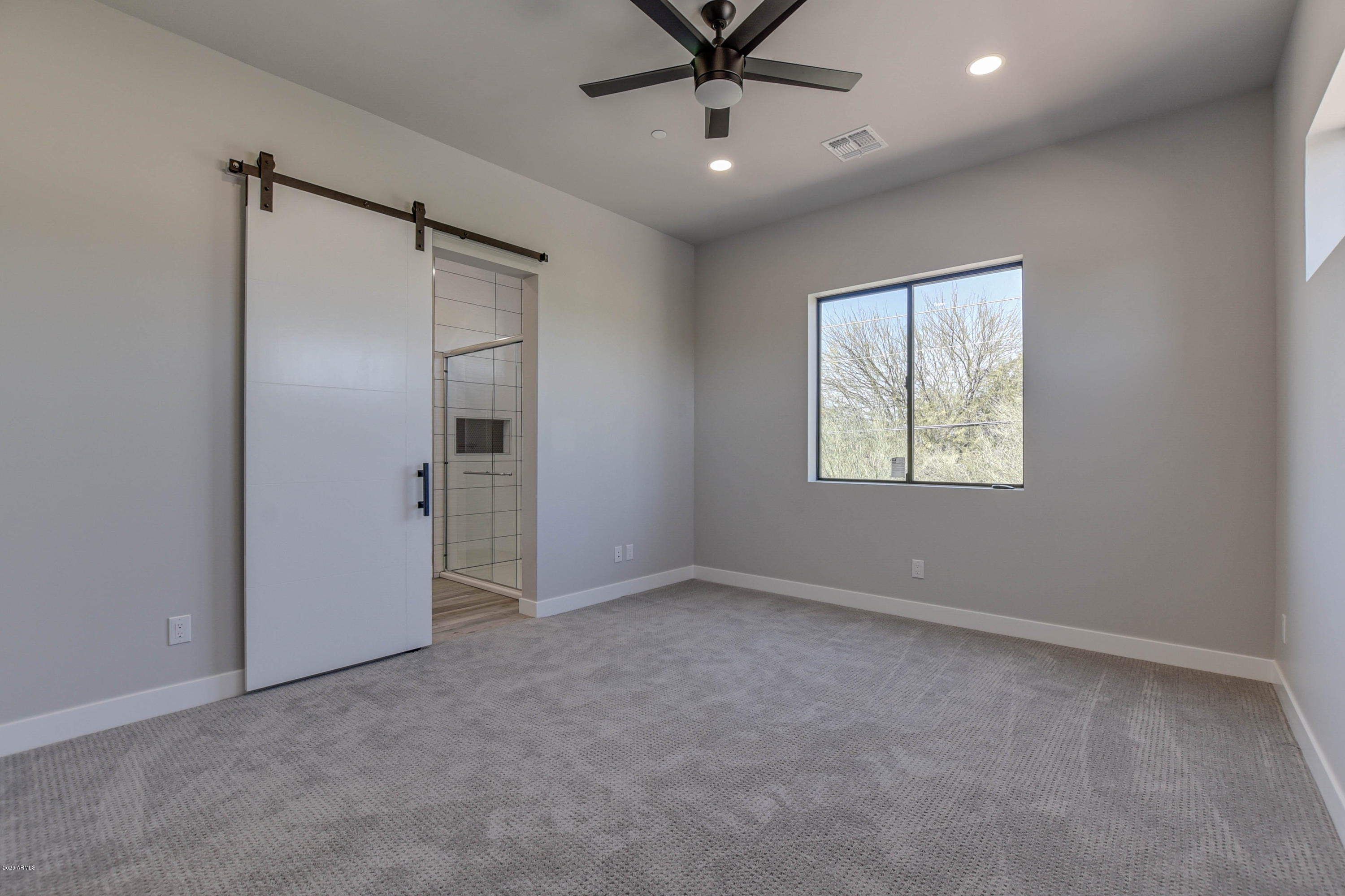 2645 East Osborn Road, Unit 6 Phoenix, AZ 85016 - Photo 27 of 43 an empty room with fan and windows