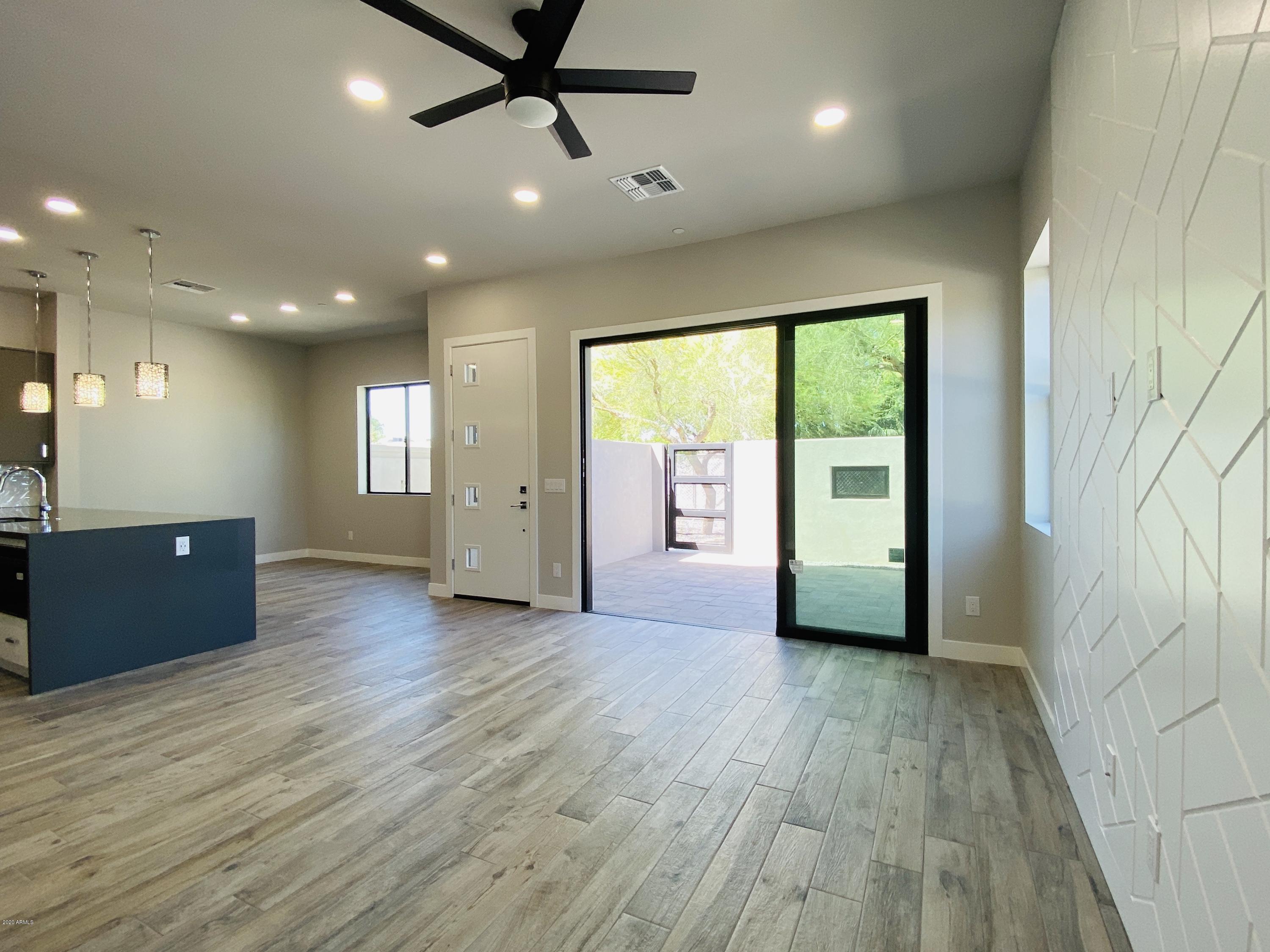 2645 East Osborn Road, Unit 6 Phoenix, AZ 85016 - Photo 40 of 43 an empty room with wooden floor and windows