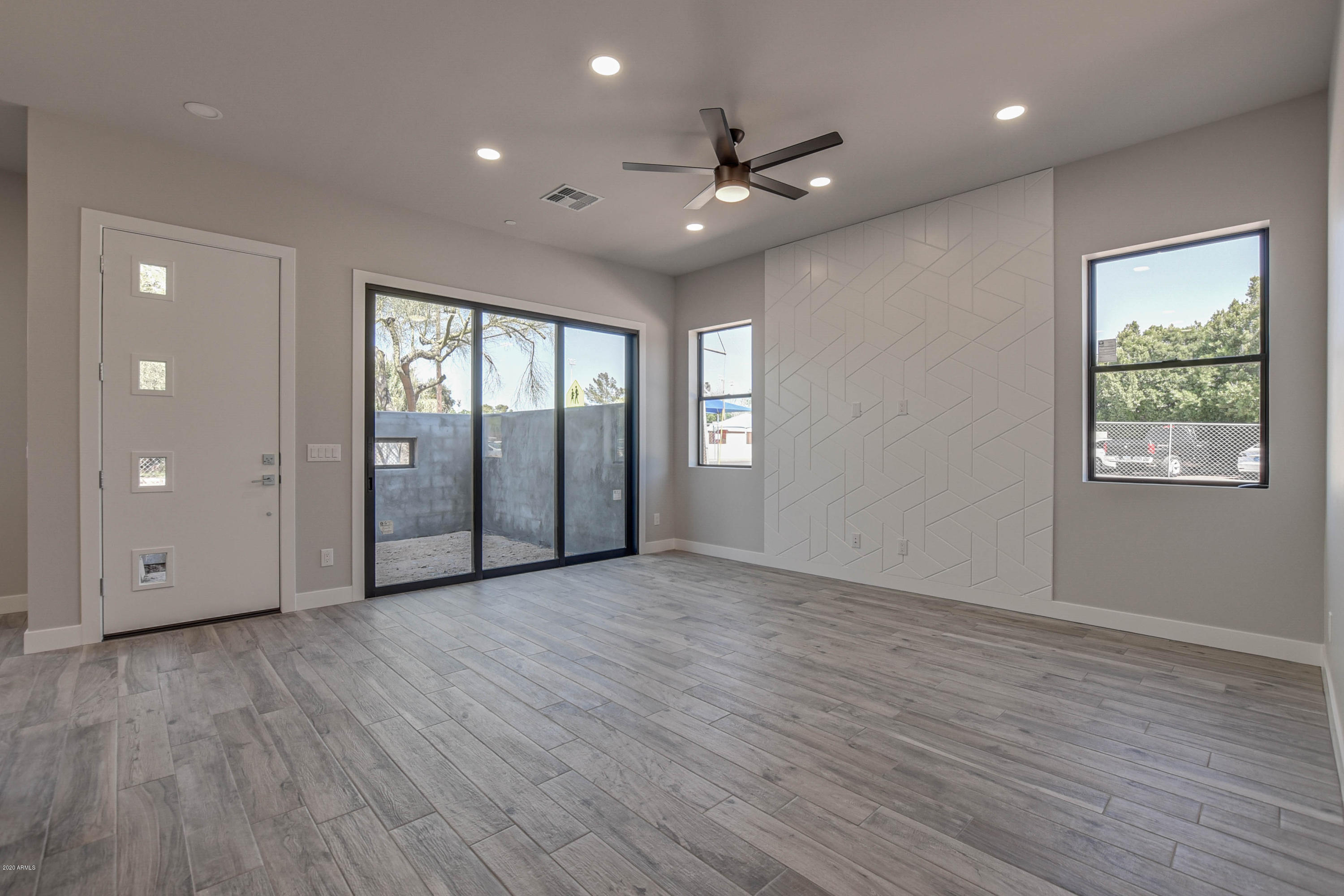 2645 East Osborn Road, Unit 6 Phoenix, AZ 85016 - Photo 8 of 43 a view of an empty room with window and wooden floor