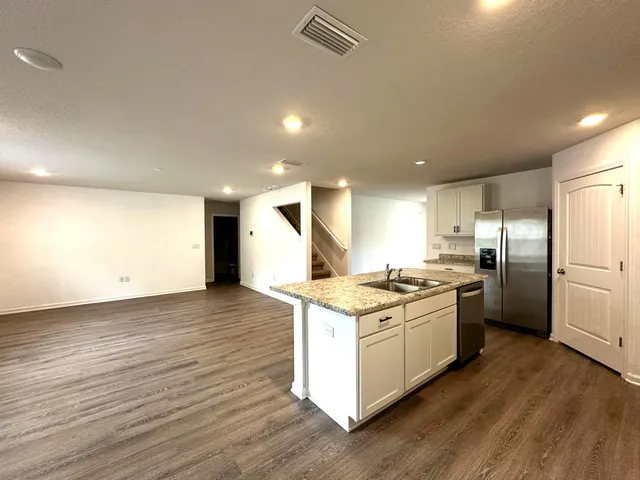 a kitchen with a stove a sink and a refrigerator
