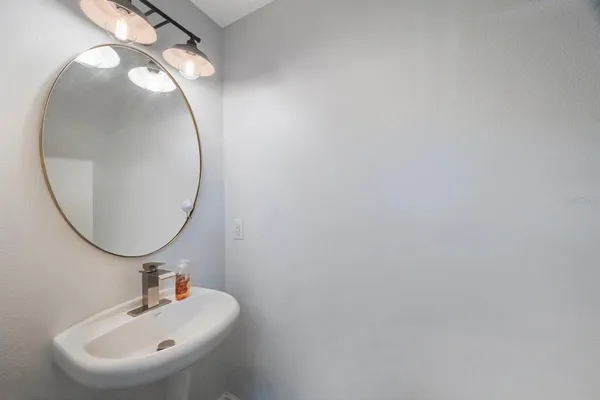 a view of kitchen with stainless steel appliances cabinets and window