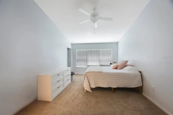 a bedroom with a bed and a dresser