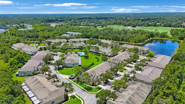 an aerial view of a house with a yard and plants