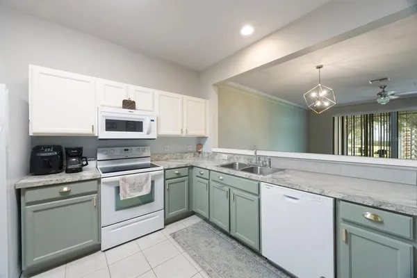 a kitchen with a refrigerator stove and sink