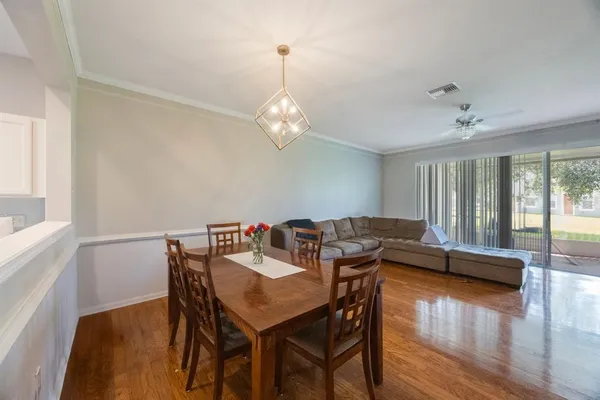a living room with furniture and a flat screen tv with wooden floor