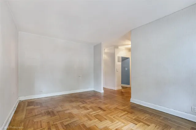 a view of a big room with wooden floor and cabinet