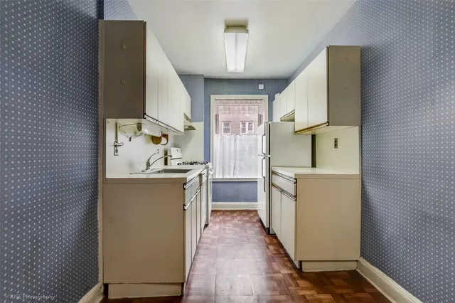 a kitchen with a sink and wooden cabinets