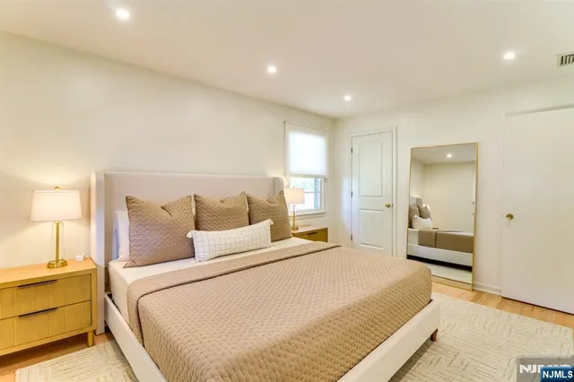 a bedroom with a bed and a large window