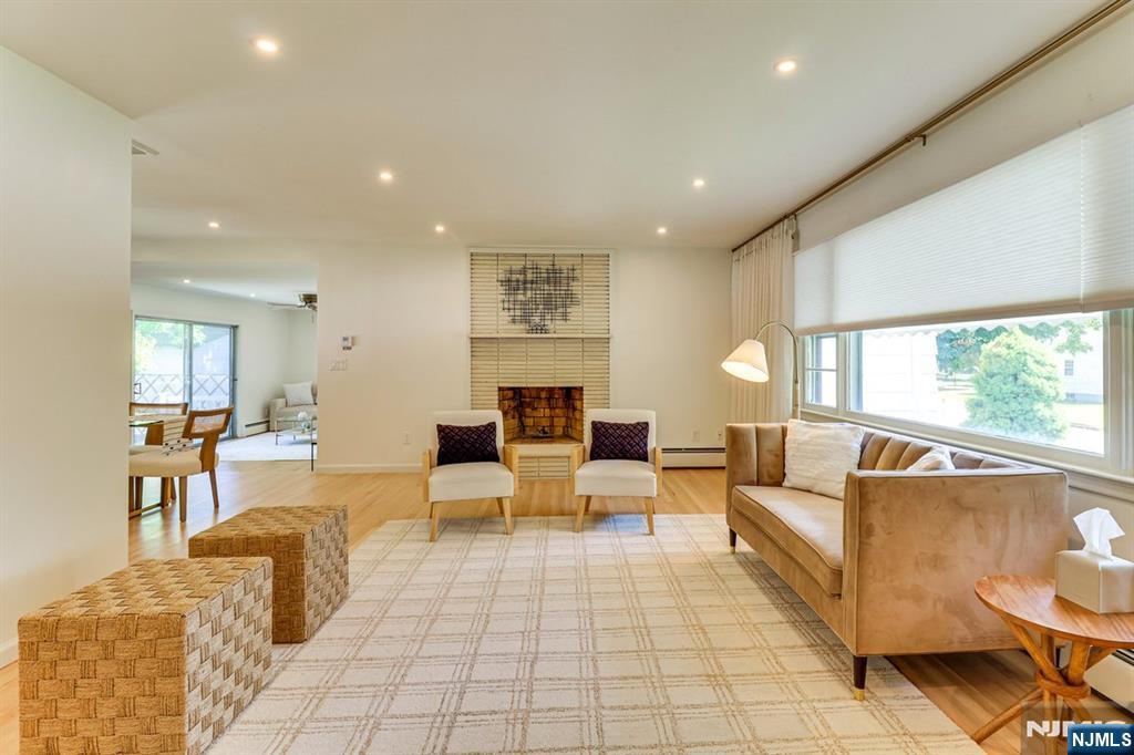 213 Haroldson Place Pompton Lakes, NJ 07442 - Photo 2 of 26 a living room with fireplace furniture and a large window