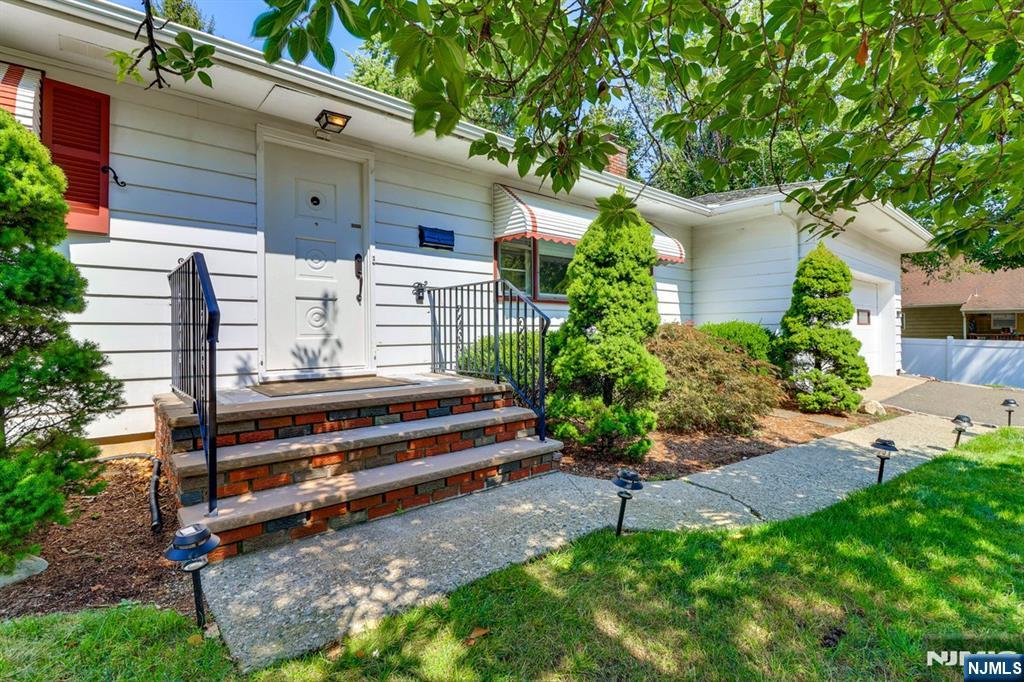 213 Haroldson Place Pompton Lakes, NJ 07442 - Photo 22 of 26 a front view of a house with a garden