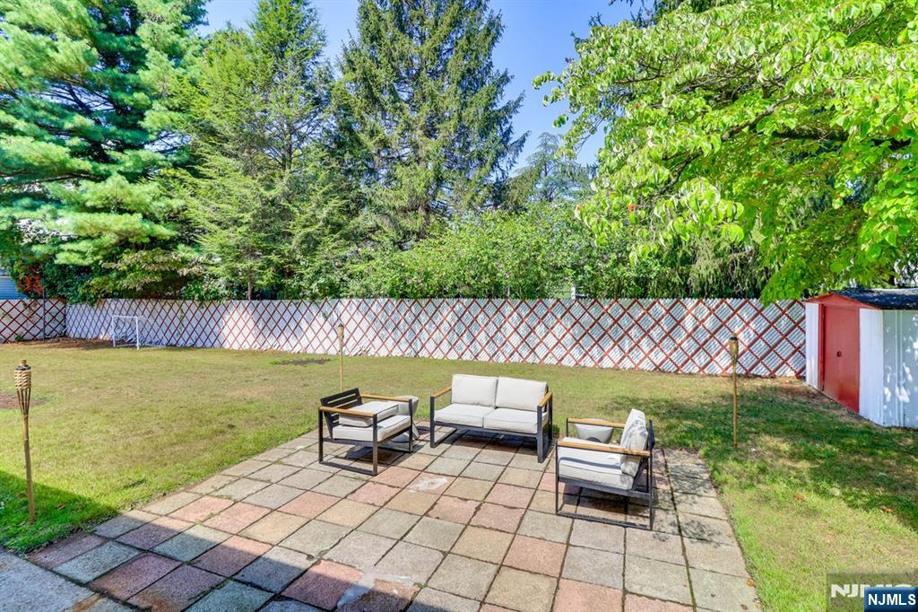 213 Haroldson Place Pompton Lakes, NJ 07442 - Photo 24 of 26 a view of a patio with lawn chairs next to a yard