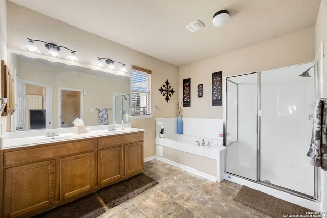 a spacious bathroom with a double vanity sink shower and a mirror