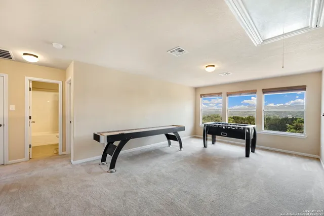 a view of an empty room with large windows