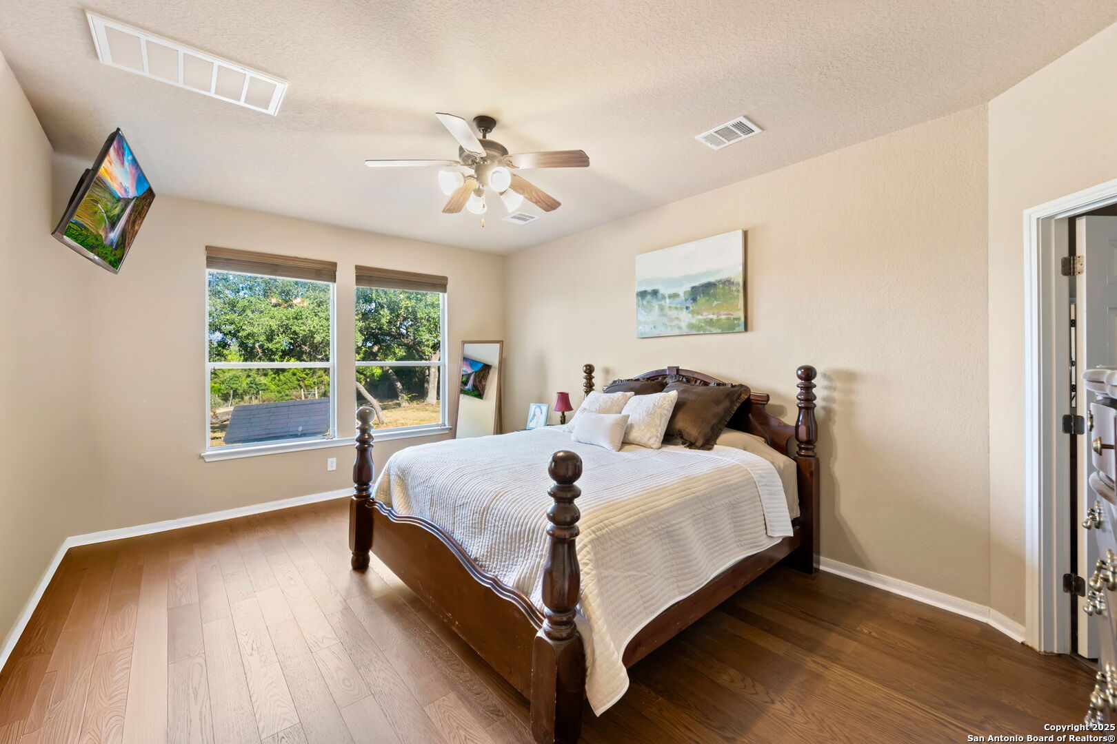 17132 Bandera Road Helotes, TX 78023 - Photo 14 of 39 a bed sitting in a spacious bedroom next to a window