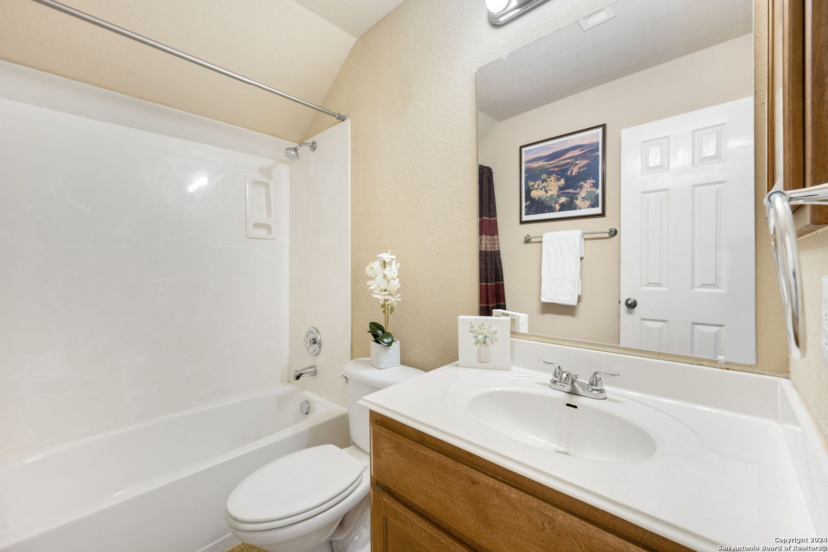 17132 Bandera Road Helotes, TX 78023 - Photo 17 of 39 a bathroom with a granite countertop sink toilet tub and shower