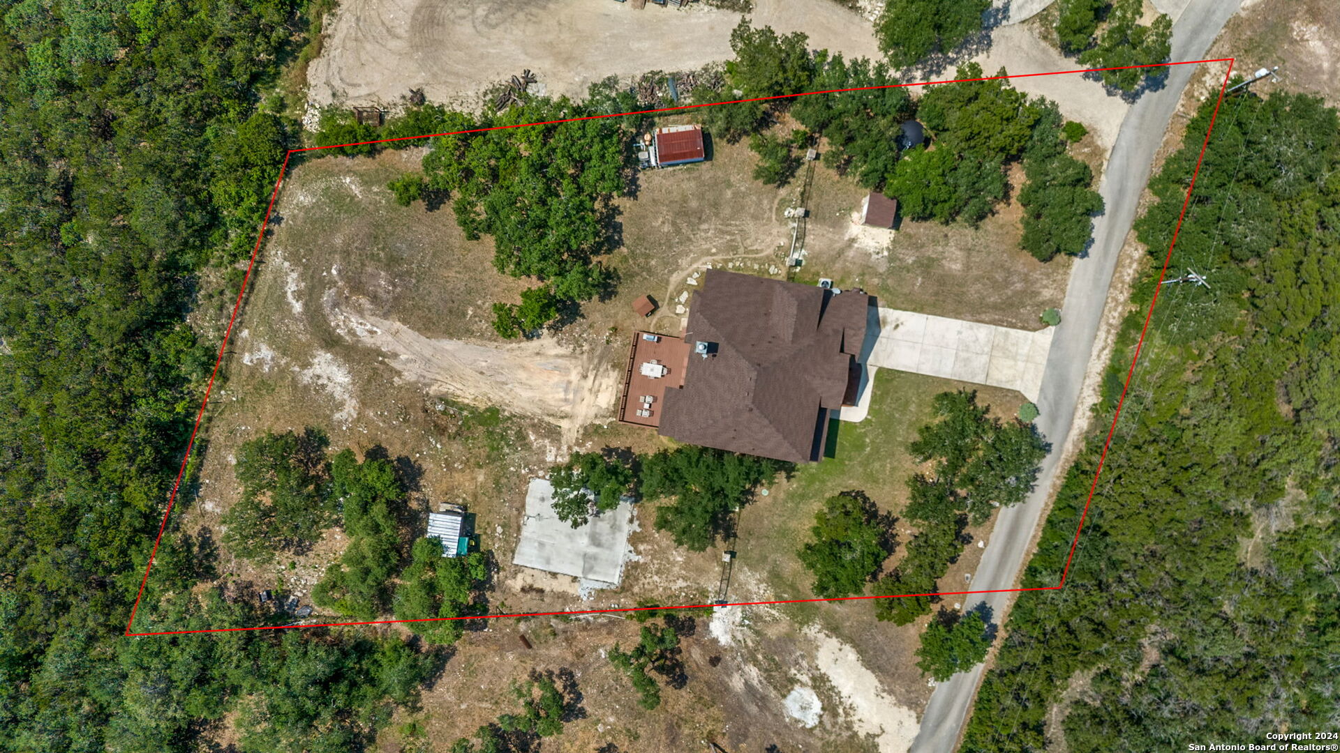 17132 Bandera Road Helotes, TX 78023 - Photo 24 of 39 an aerial view of a house with a yard and a large tree