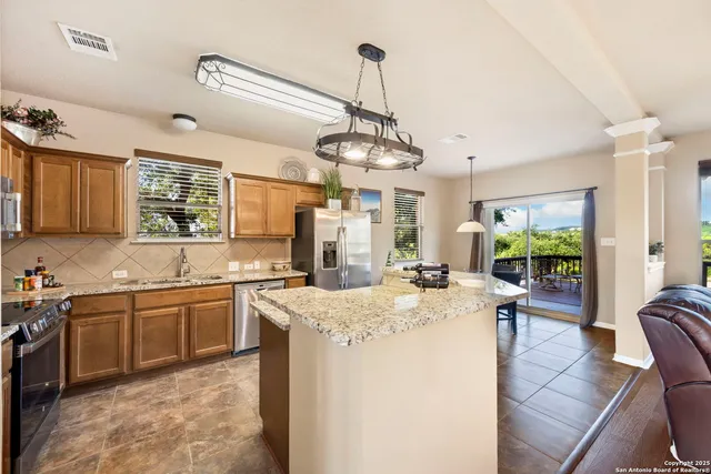 a kitchen with sink stove and cabinets