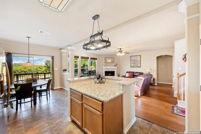 a view of a dining room and livingroom with furniture wooden floor a chandelier