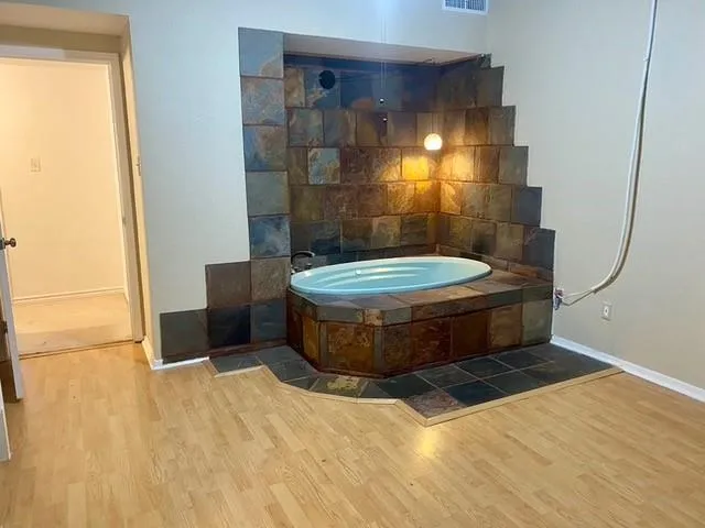 a view of water heater room with a bathroom