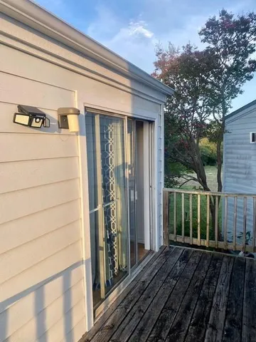 a backyard of a house with grass and wooden fence
