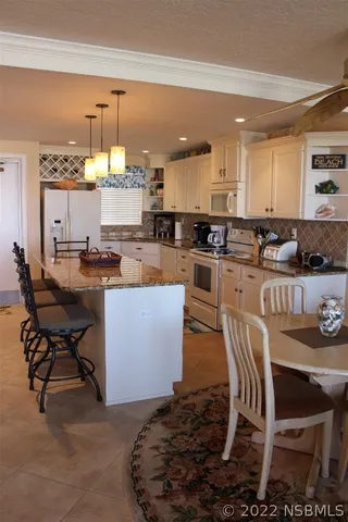 a kitchen with a dining table chairs and view kitchen