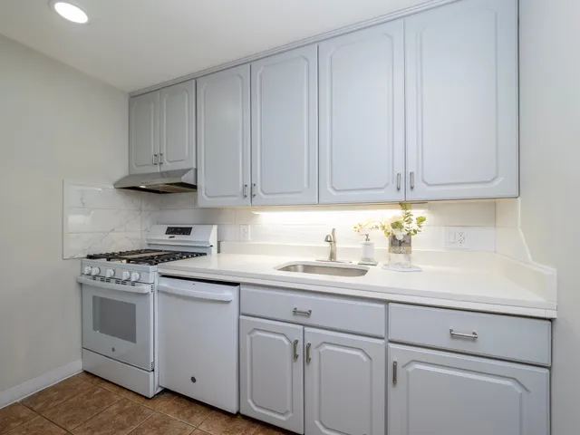 a kitchen with a white cabinets and white appliances