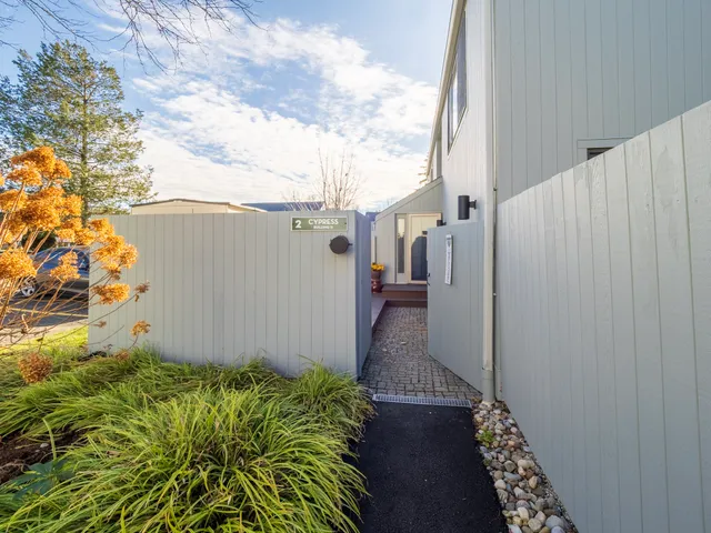 a view of a pathway of a house with a yard