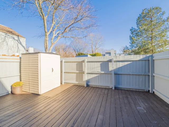 a view of a wooden deck and a yard